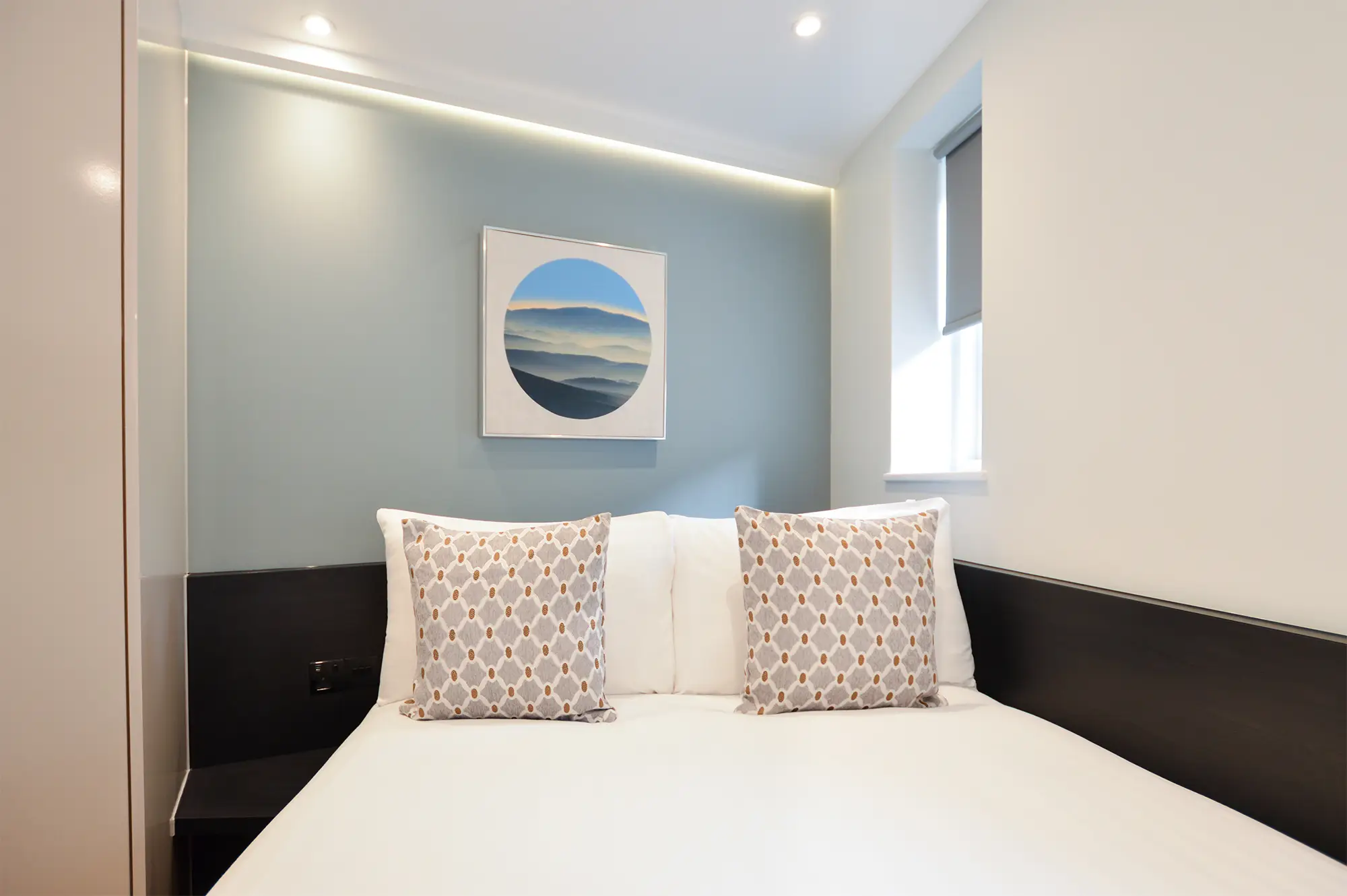 A light-filled small studio apartment with a luxurious double bed and hardwood floors with underfloor heating in a chic serviced studio apartment at 162 New Cavendish St, Marylebone, Central London