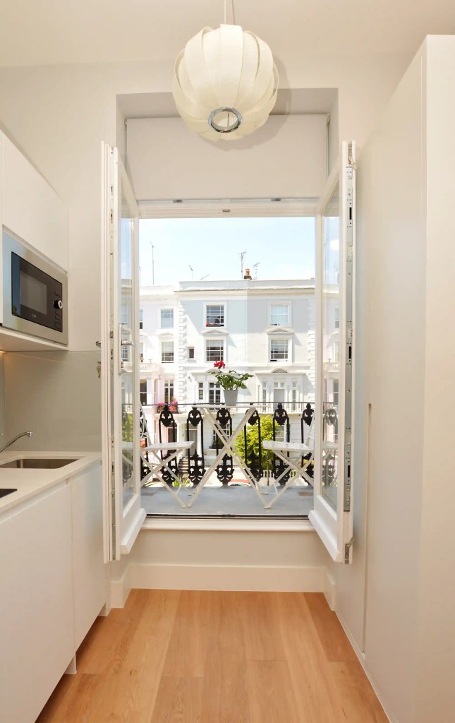 An interior-designed studio apartment with a cozy double bed, located near Portobello Road in Notting Hill, London