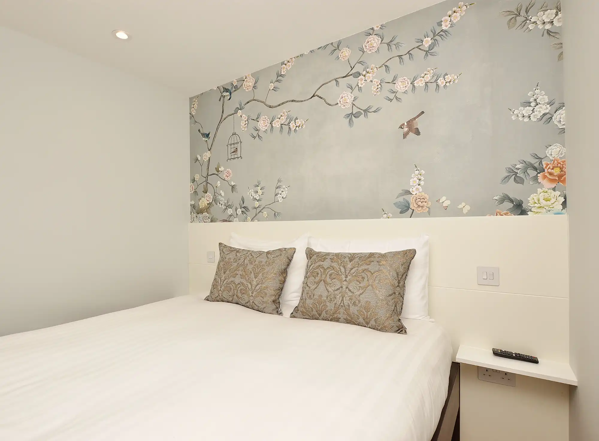 A cozy double bed in a large studio at StayPrime Serviced Apartments, located on Portobello Road in Notting Hill