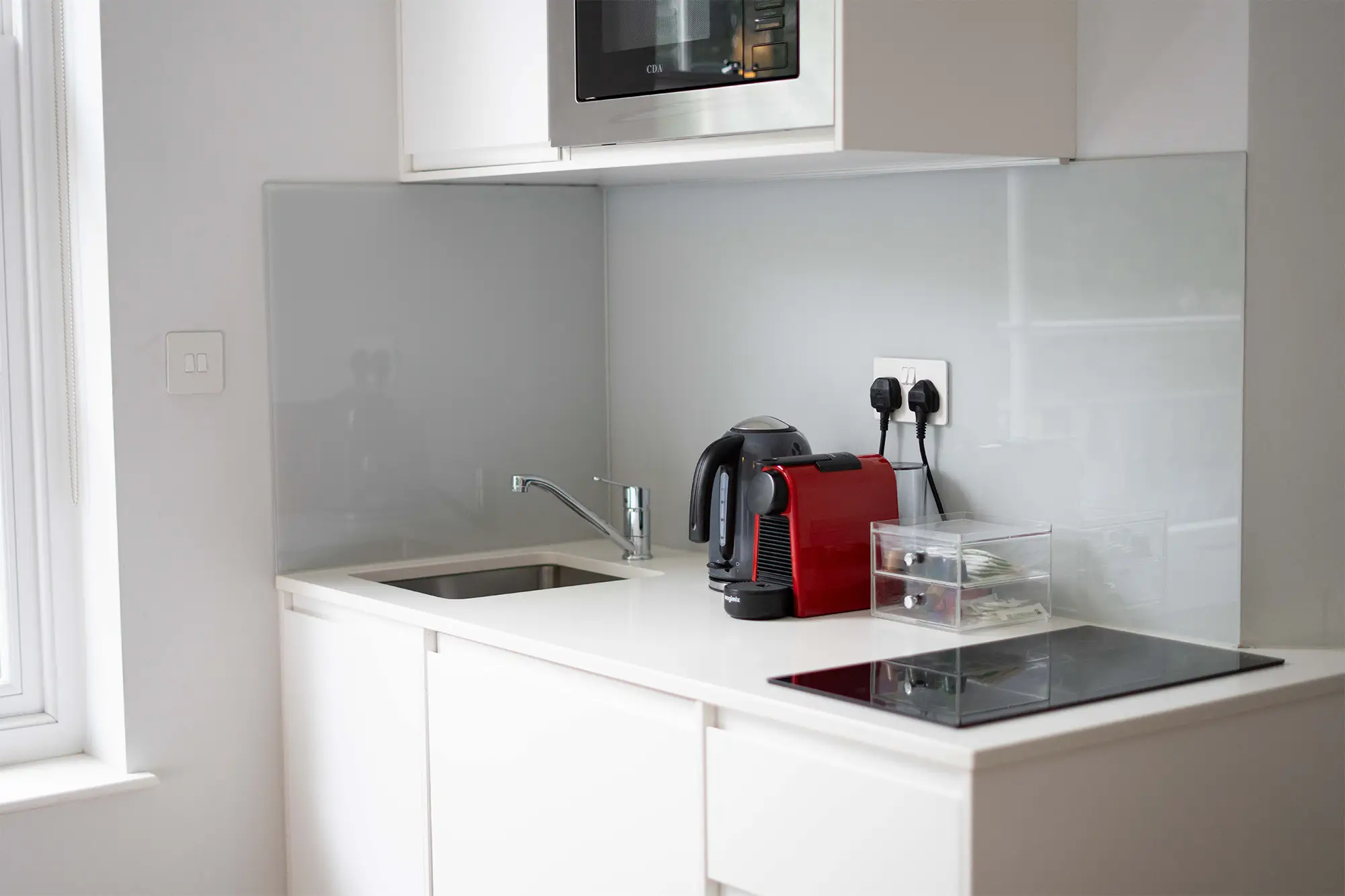 That looks great! Here’s a slightly polished version: Modern studio apartment at 37 Chepstow Villas, Notting Hill, featuring a fully equipped kitchen with a Nespresso coffee machine