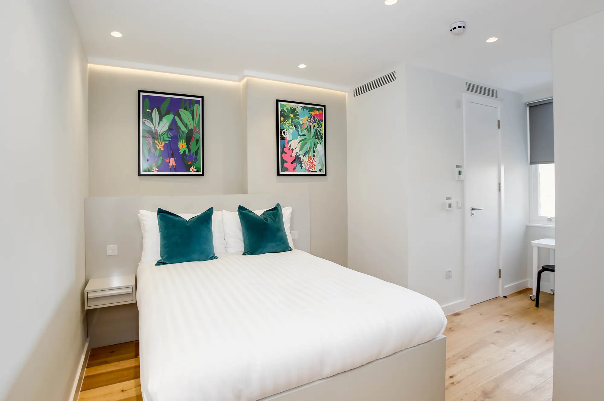A cozy sleeping area and wardrobe space in a studio apartment at 3 Knaresborough Place, Kensington, London