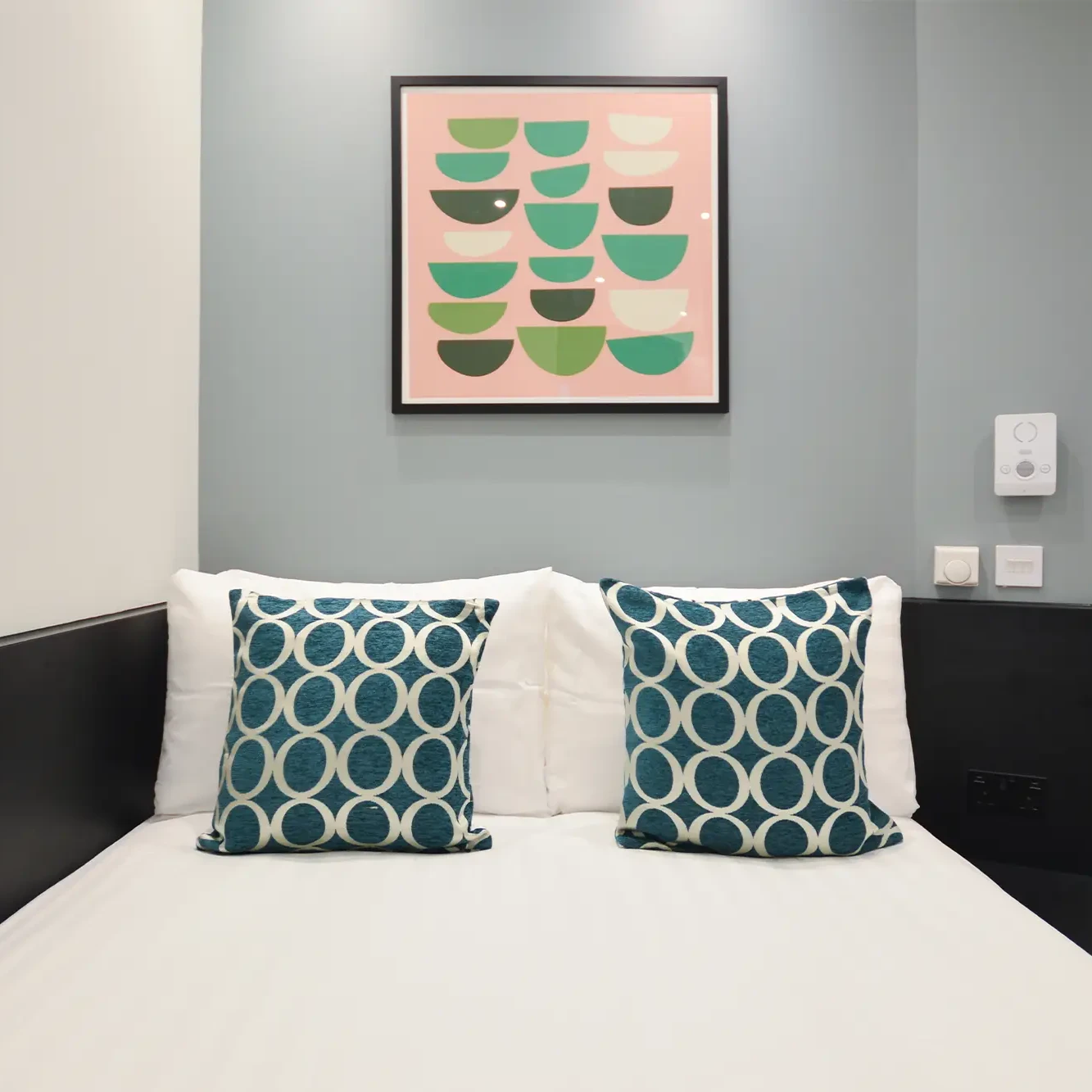 Beautiful wall art and a luxury double bed in a small studio apartment in Marylebone at 162 New Cavendish St, London