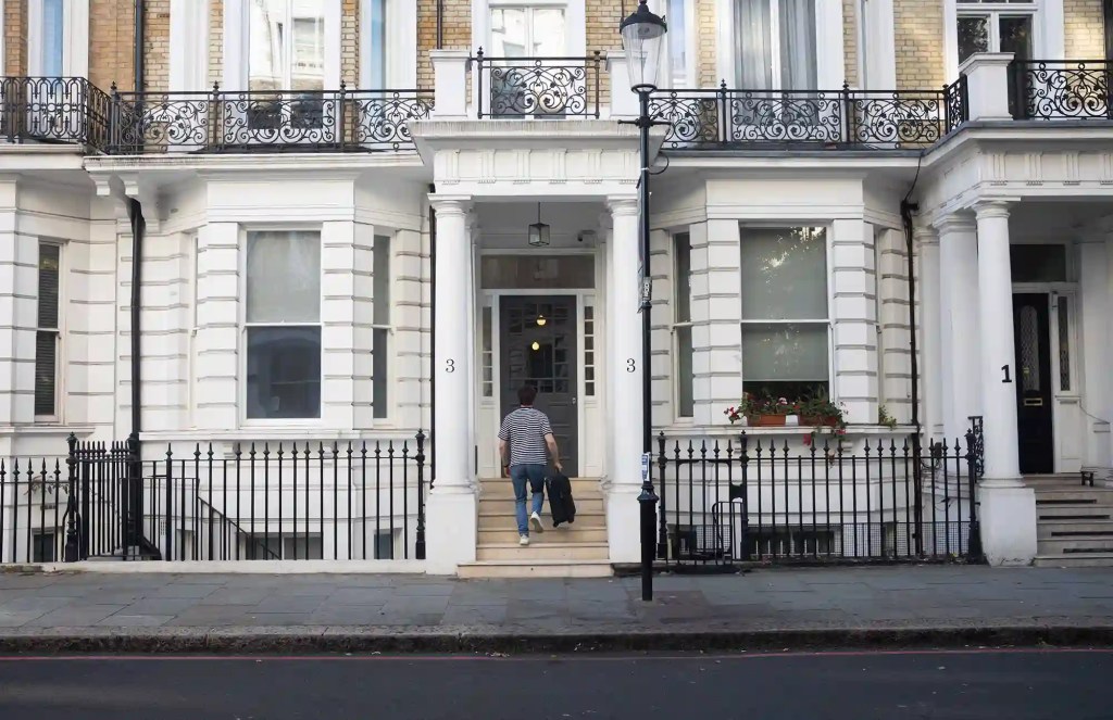 A young student entering the gorgeous StayPrime serviced apartment building at 3 Knaresborough Place, Kensington