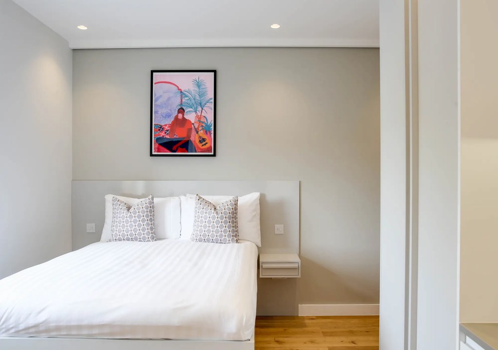 Stylish double bed in a Kensington small studio apartment at Cromwell Apartments, 3 Knaresborough Place.