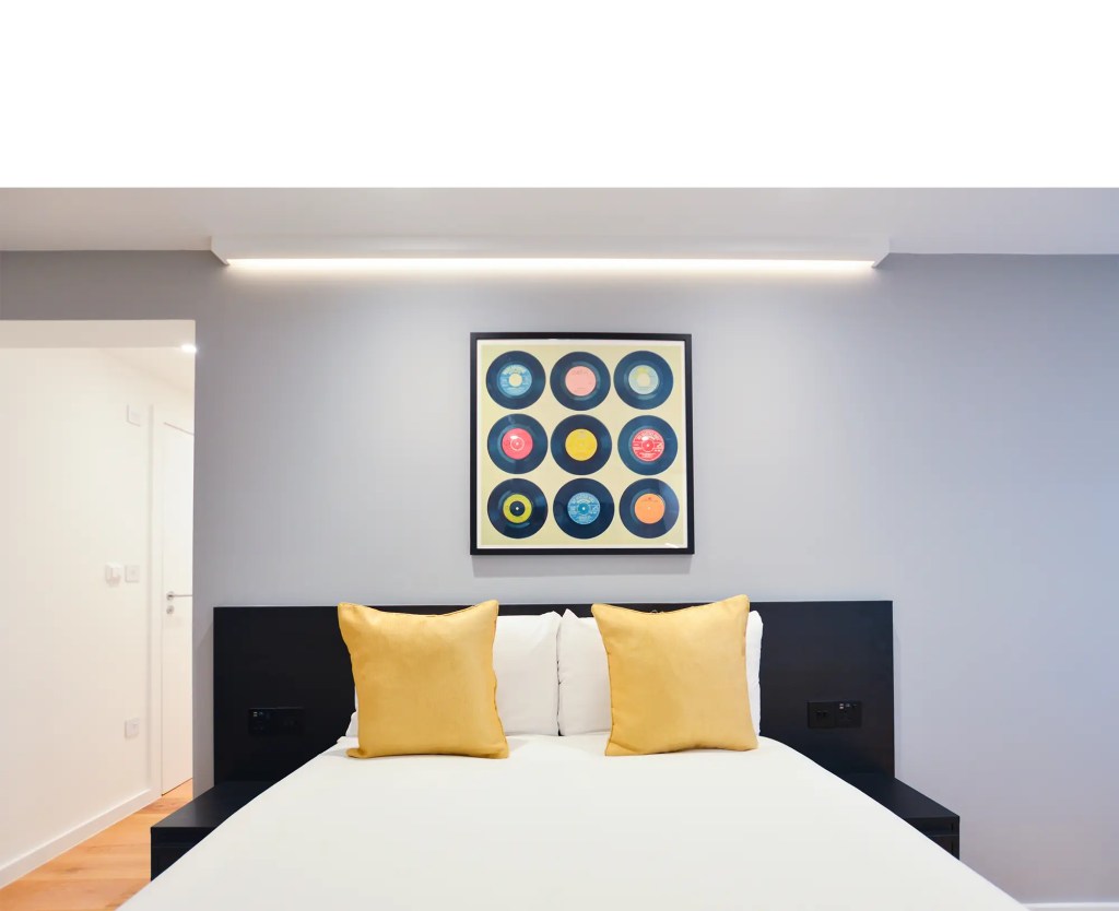 Stylish double bed in a large lower ground studio in Marylebone at 162 New Cavendish, London.