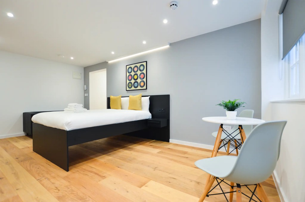 A stylish large lower ground studio in Marylebone with a cosy dining area and a double bed. At Stayprime Serviced Apartments London