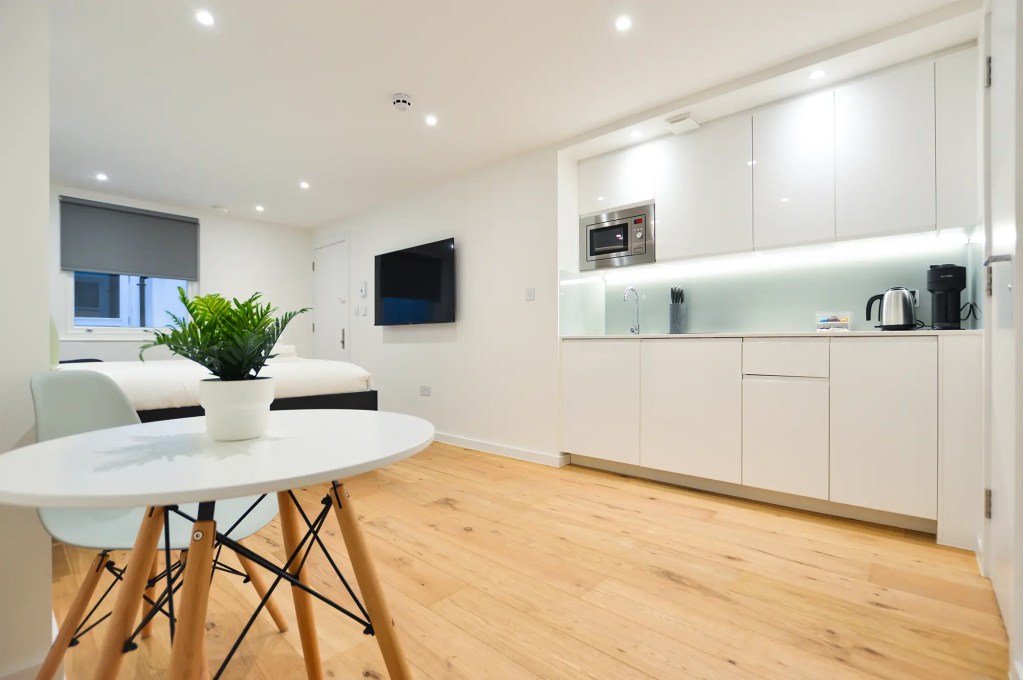 Stylish double bed in a large lower ground studio in Marylebone at 162 New Cavendish, London.