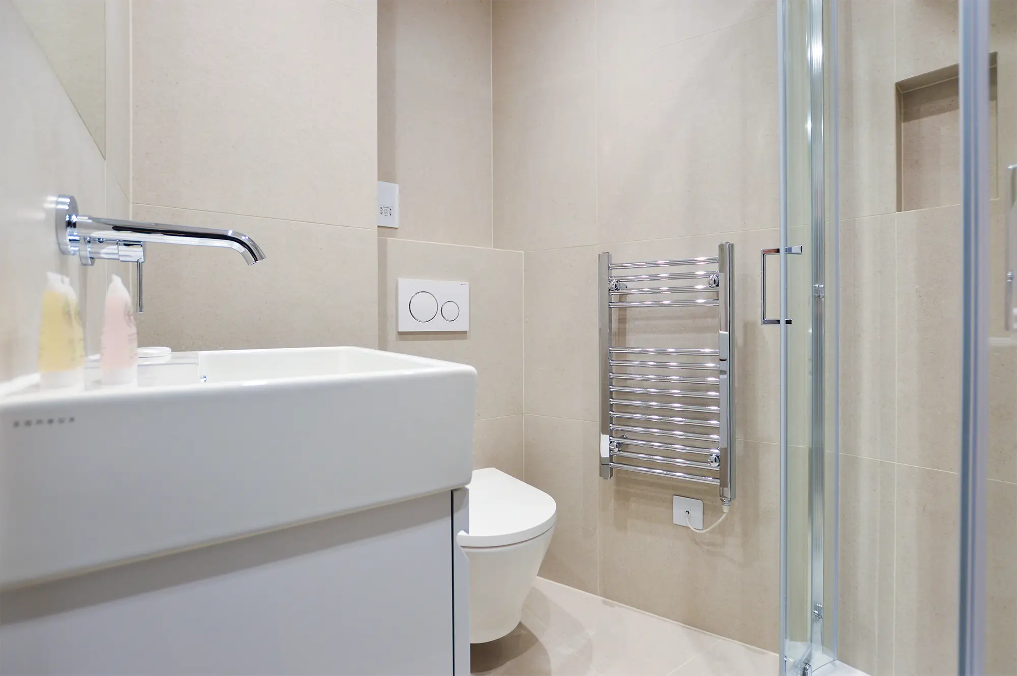 Clean and modern private bathroom with a shower, towel warmer, and underfloor heating in a luxury studio in Marylebone at 162 New Cavendish, London, near the BT Towe