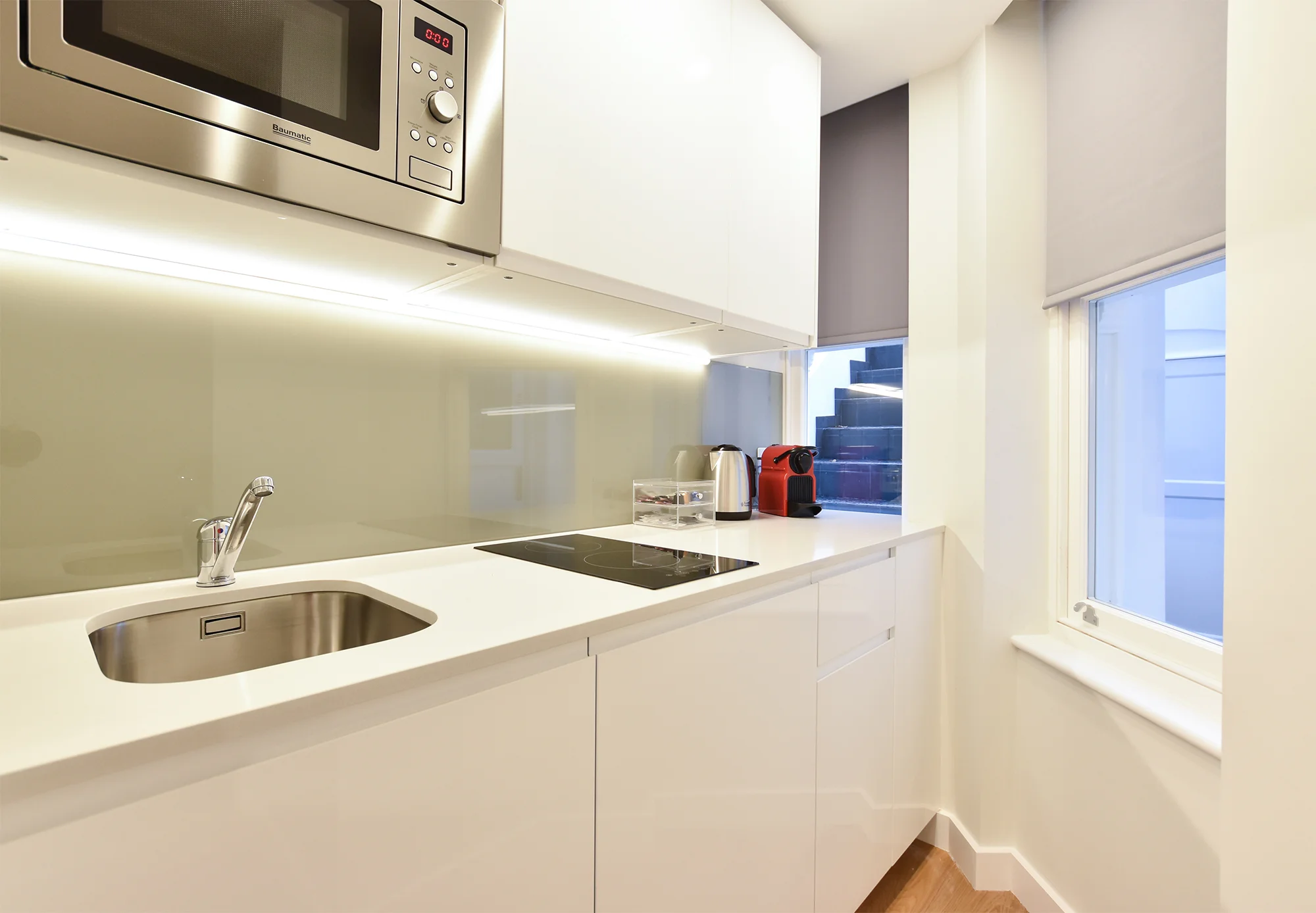 Indulge in a holiday escape at Kensington Serviced Apartments by Stayprime in London. Immerse yourself in the charm of this fully equipped kitchen and inviting dining area, creating the ideal space for short-term lets. Discover the perfect blend of comfort and convenience in the heart of London for your holiday getaway