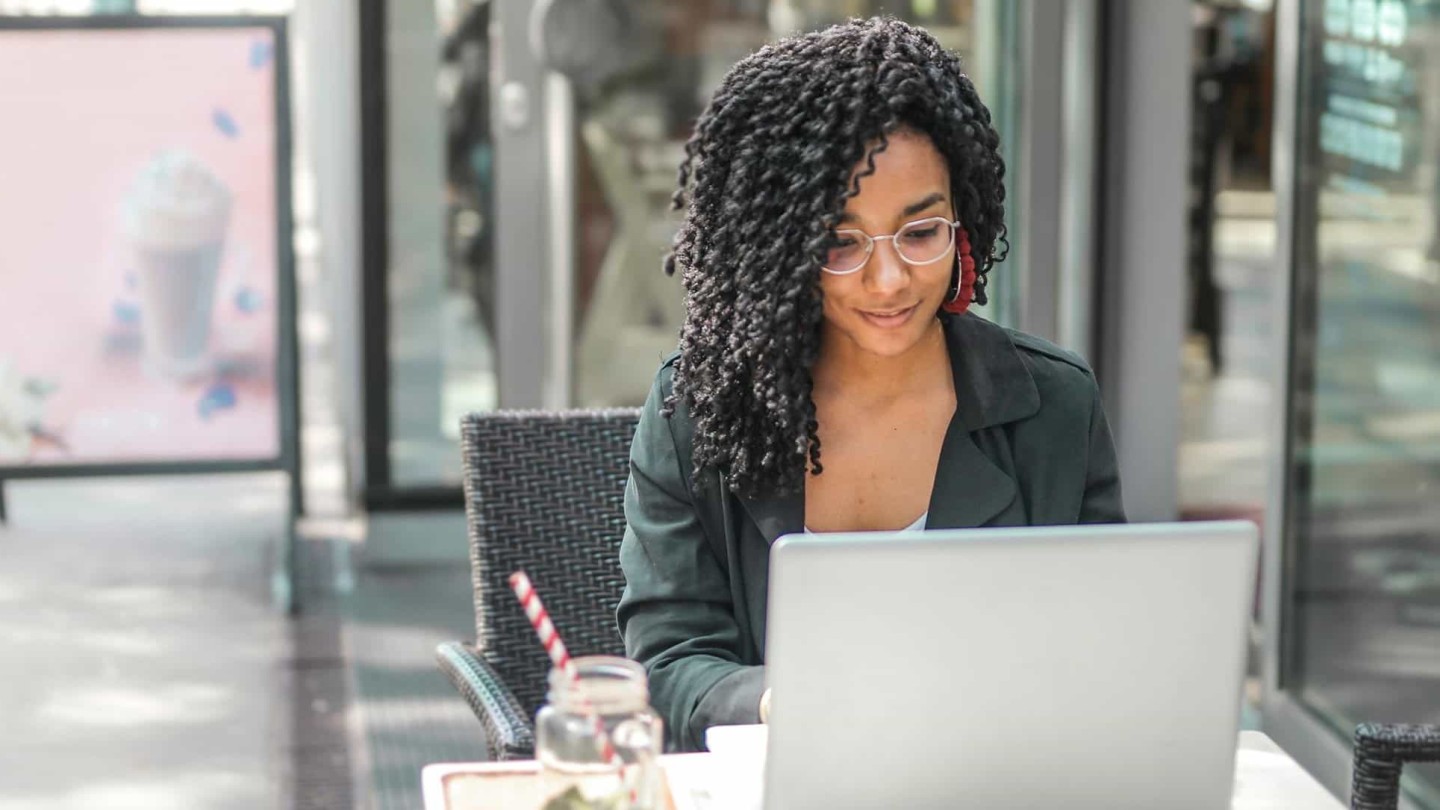 Young professional working on her computer at GAIL's Bakery in central London, near Kensington Serviced Apartments