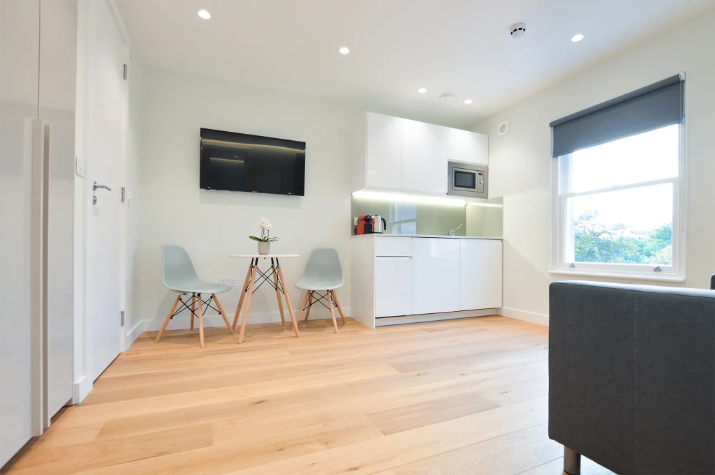 Stylish kitchen and dining area in a spacious one-bedroom apartment at Earls Court serviced apartments
