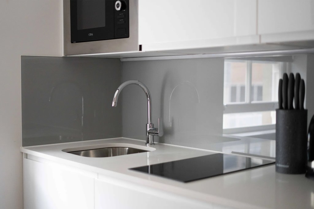 Premium kitchen appliances in a fully equipped kitchenette in a luxurious serviced apartment in London.