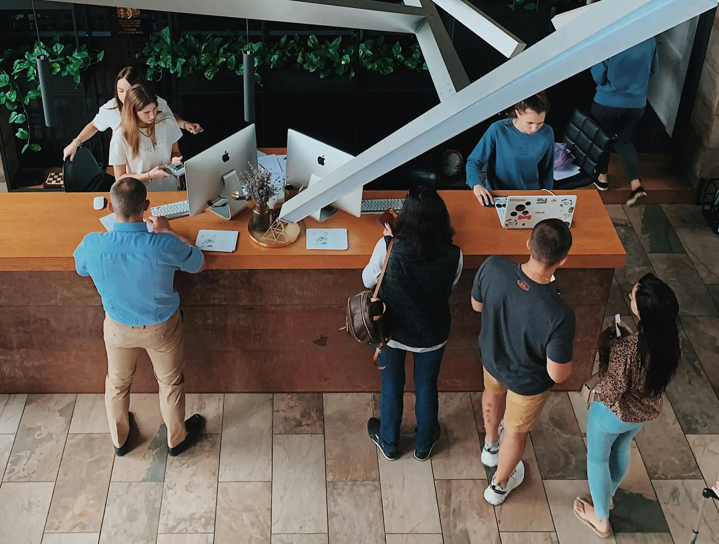 A hotel reception in Central London with young professionals waiting to check in