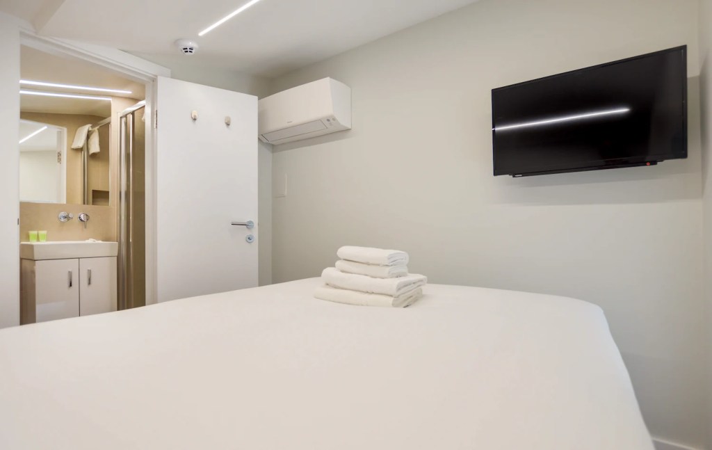 Roomy one bedroom apartment in Fitzrovia with separate sleeping and dining areas, including a table and chairs, at Stayprime Serviced Apartments, London
