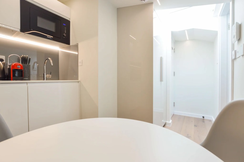 Roomy one bedroom apartment in Fitzrovia with separate sleeping and dining areas, including a table and chairs, at Stayprime Serviced Apartments, London
