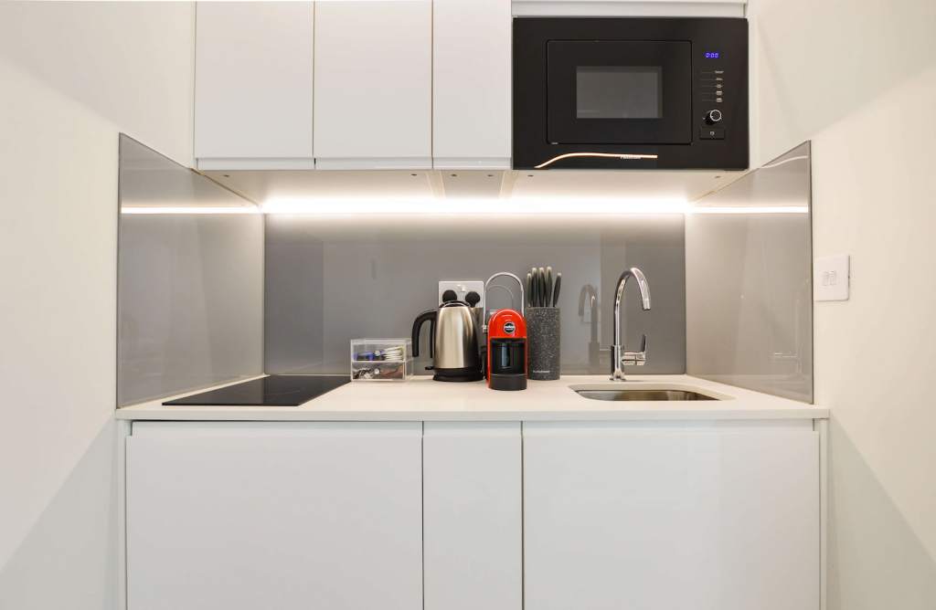 Roomy one bedroom apartment in Fitzrovia with separate sleeping and dining areas, including a table and chairs, at Stayprime Serviced Apartments, London