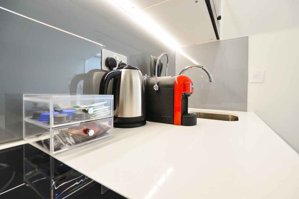 Roomy one bedroom apartment in Fitzrovia with separate sleeping and dining areas, including a table and chairs, at Stayprime Serviced Apartments, London