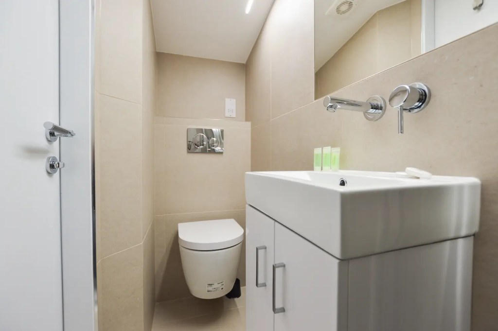 Roomy one bedroom apartment in Fitzrovia with separate sleeping and dining areas, including a table and chairs, at Stayprime Serviced Apartments, London