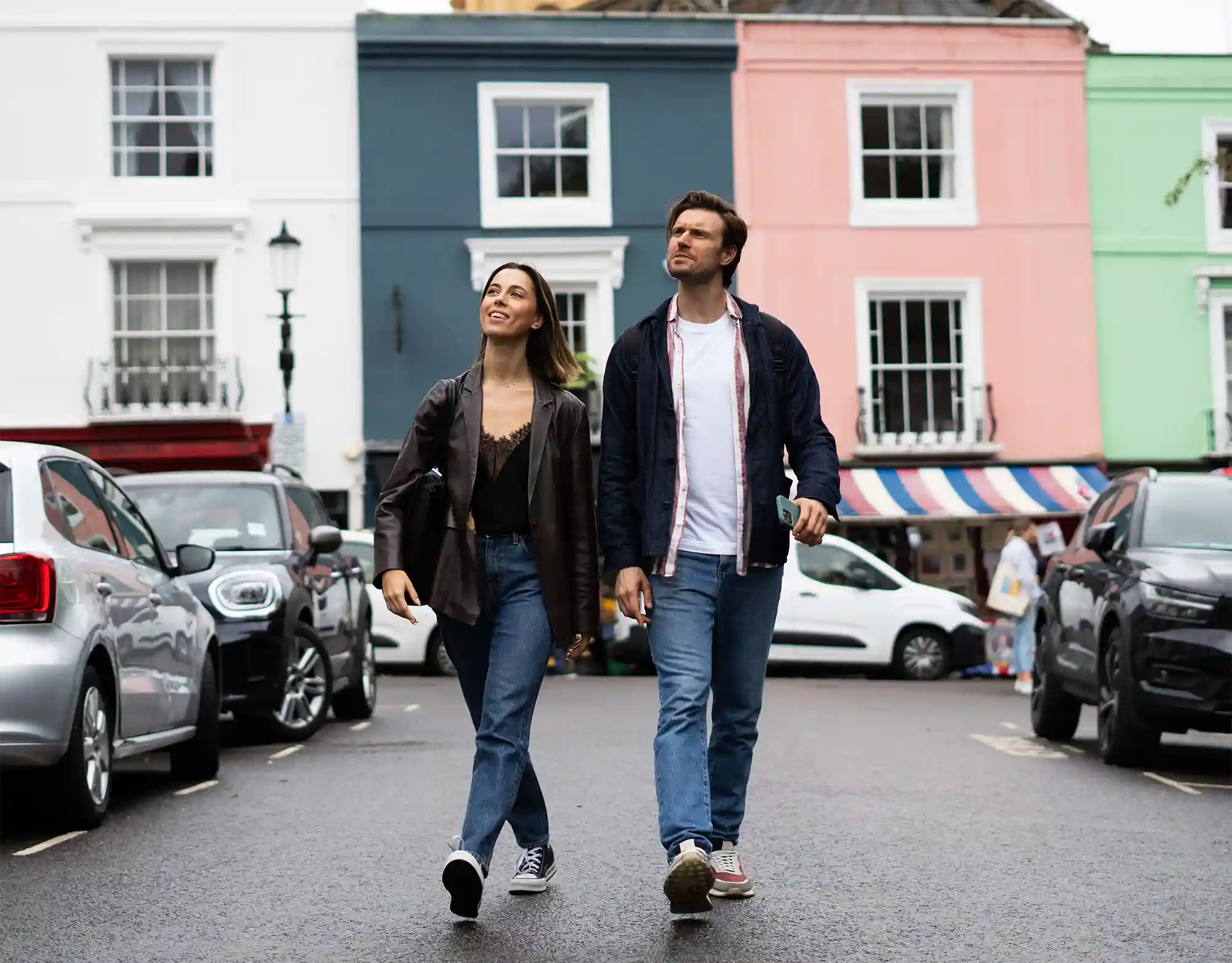 A young couple walking on Portobello Road in Notting Hill, near the Notting Hill serviced apartments in London
